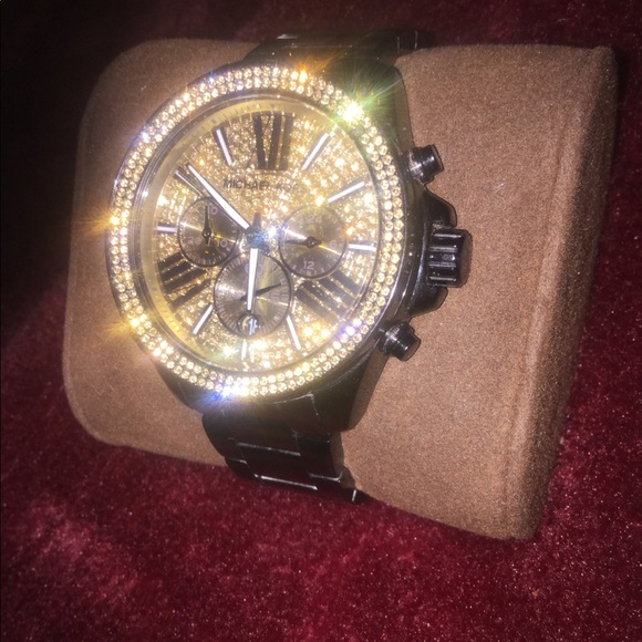 Round gold watch with black leather strap
